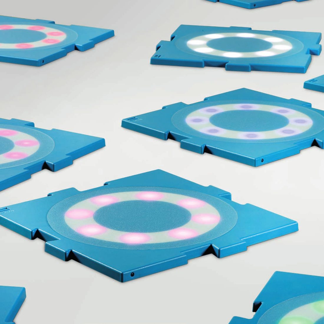 MOTO tiles spread out, lit in different colours