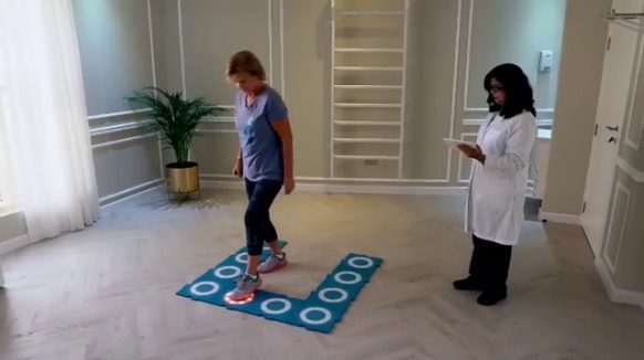 A therapist timing a woman's health test on MOTO tiles