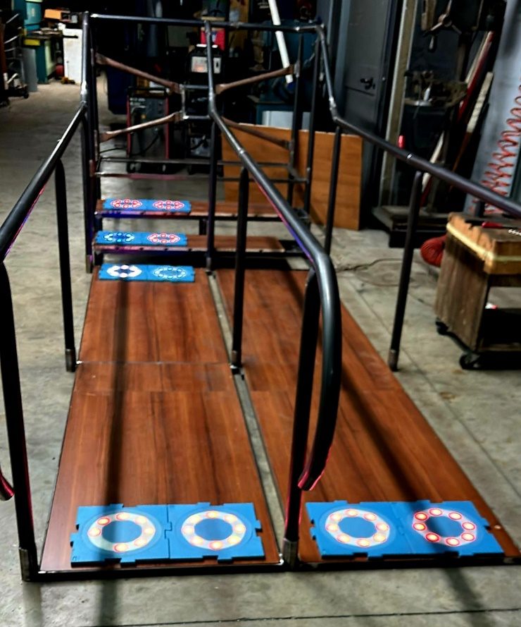 A MOTO Tiles Rehab Track with parallel walking bars and tiles built into the floor