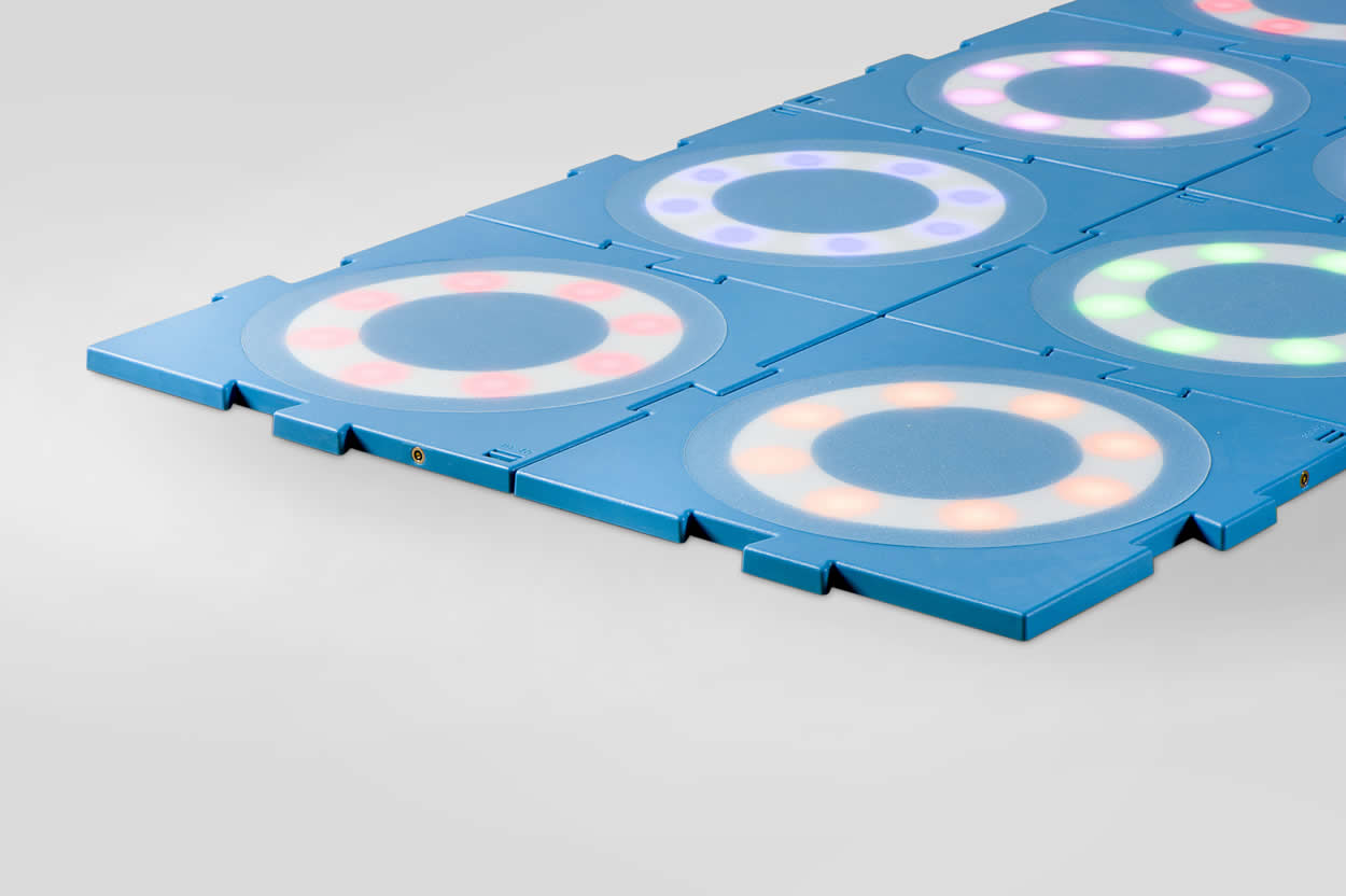 MOTO tiles clicked together, lit in different colours